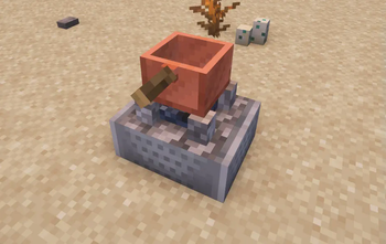 Copper cookpot on the ground