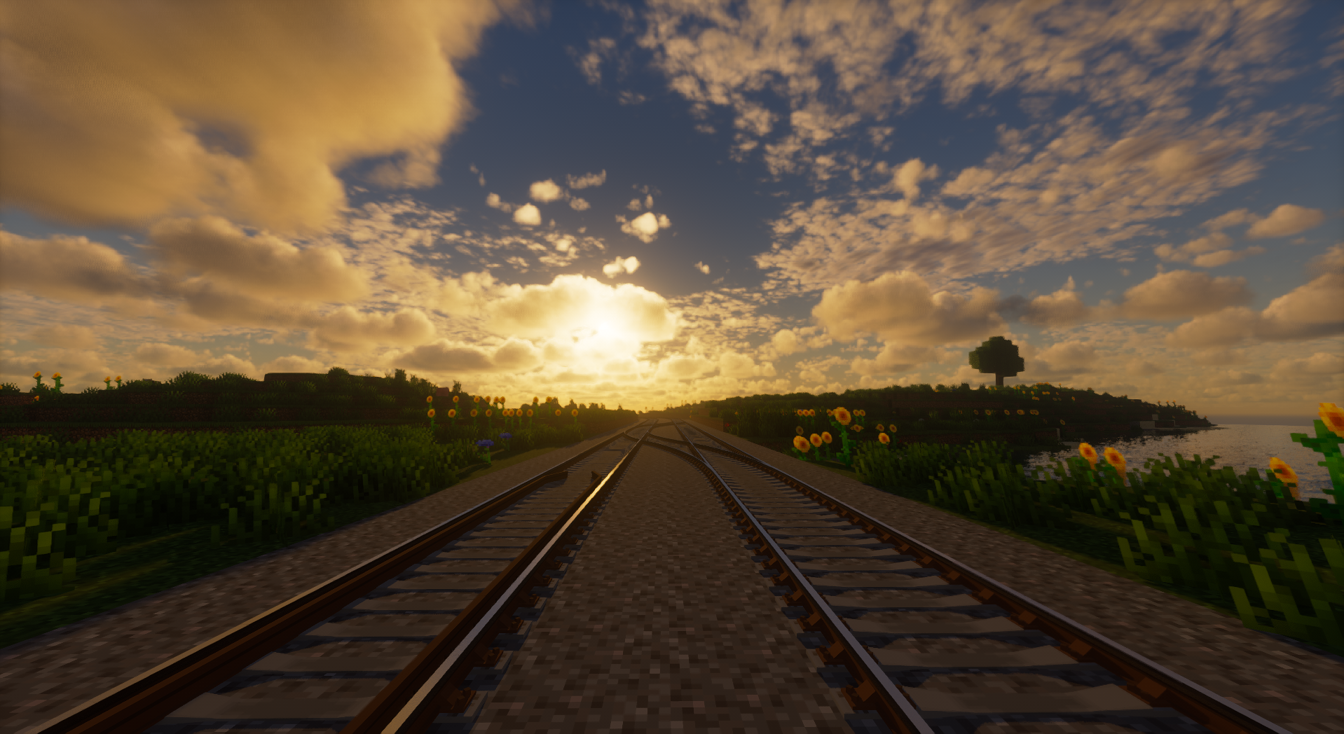 Two parallel rail tracks stretching towards a sunset, the left with a counter rail