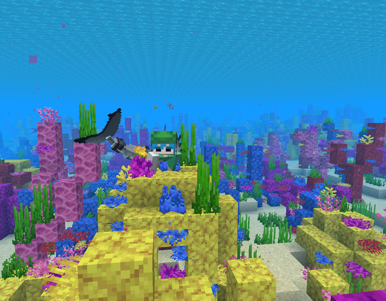 A Minecraft Merling with a shark tail lying on a yellow coral reef
