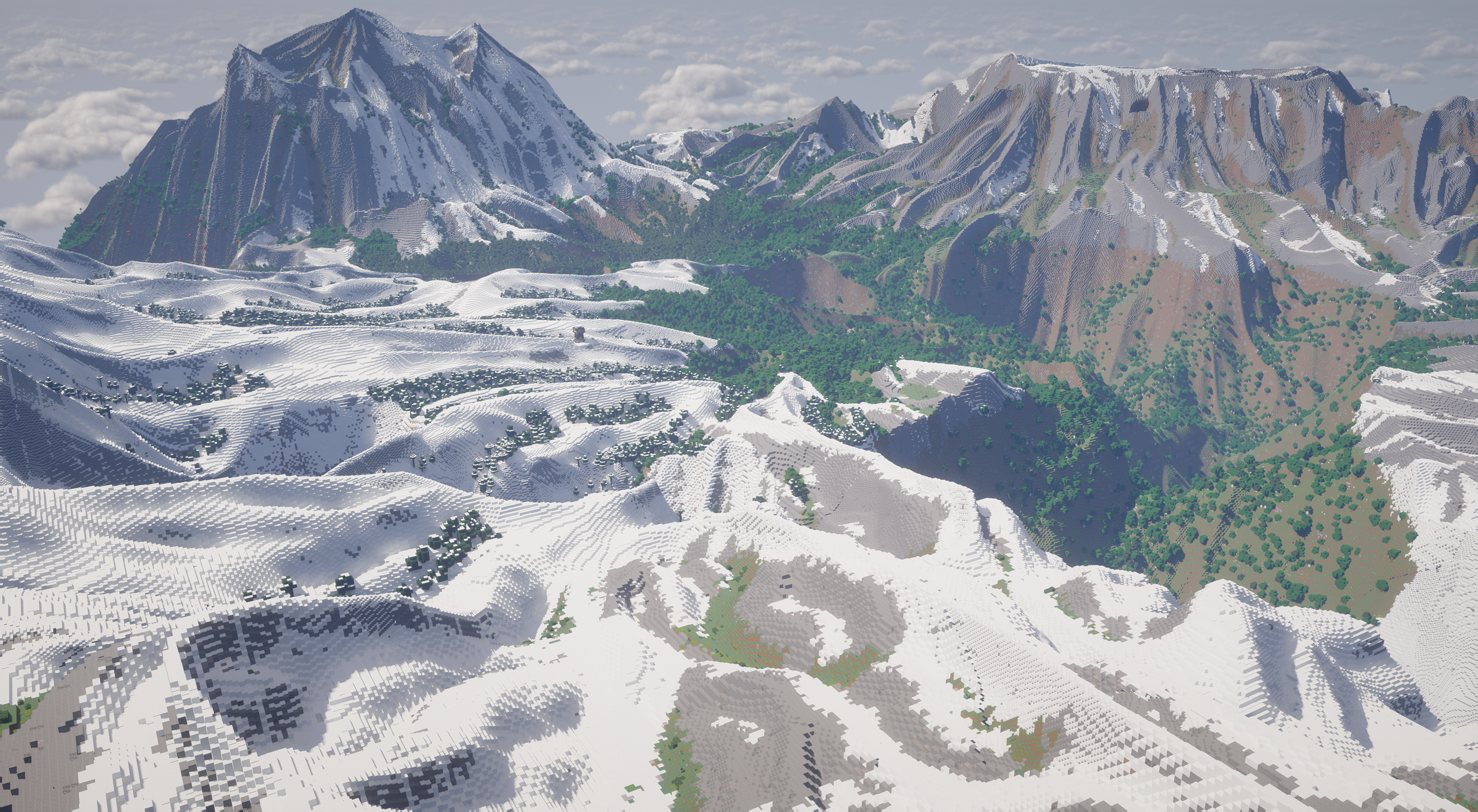 Forest valley surrounded by snowy mountains