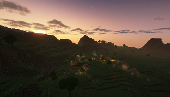 The sun sets over a village