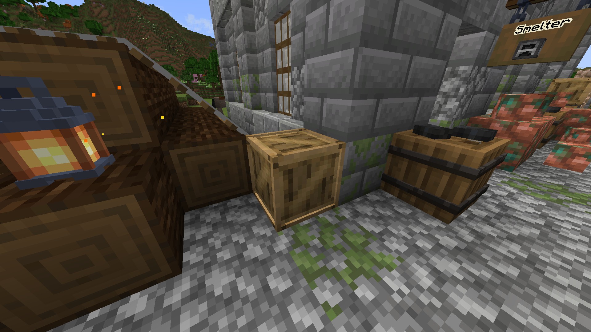 A crate between a pile of logs and a barrel