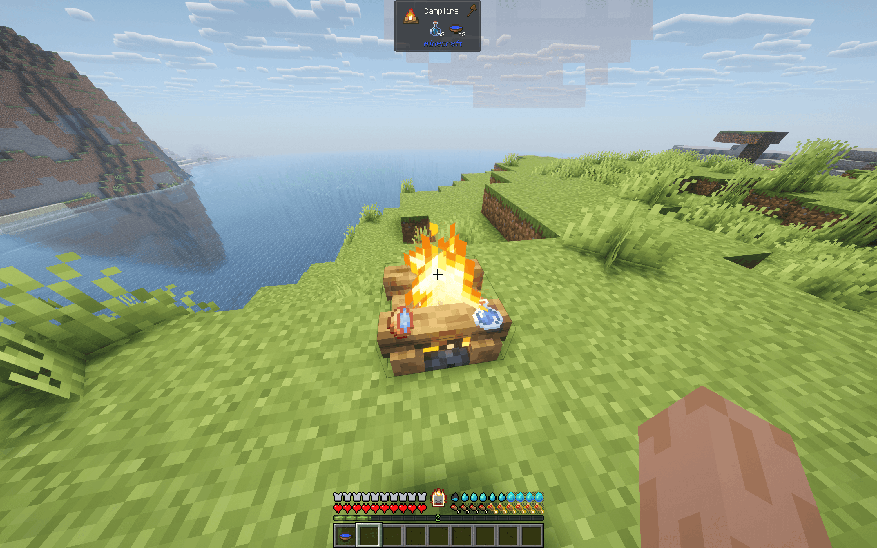 A screenshot showing water bottles and terracotta water bowls placed on top of a lit Campfire, being boiled.