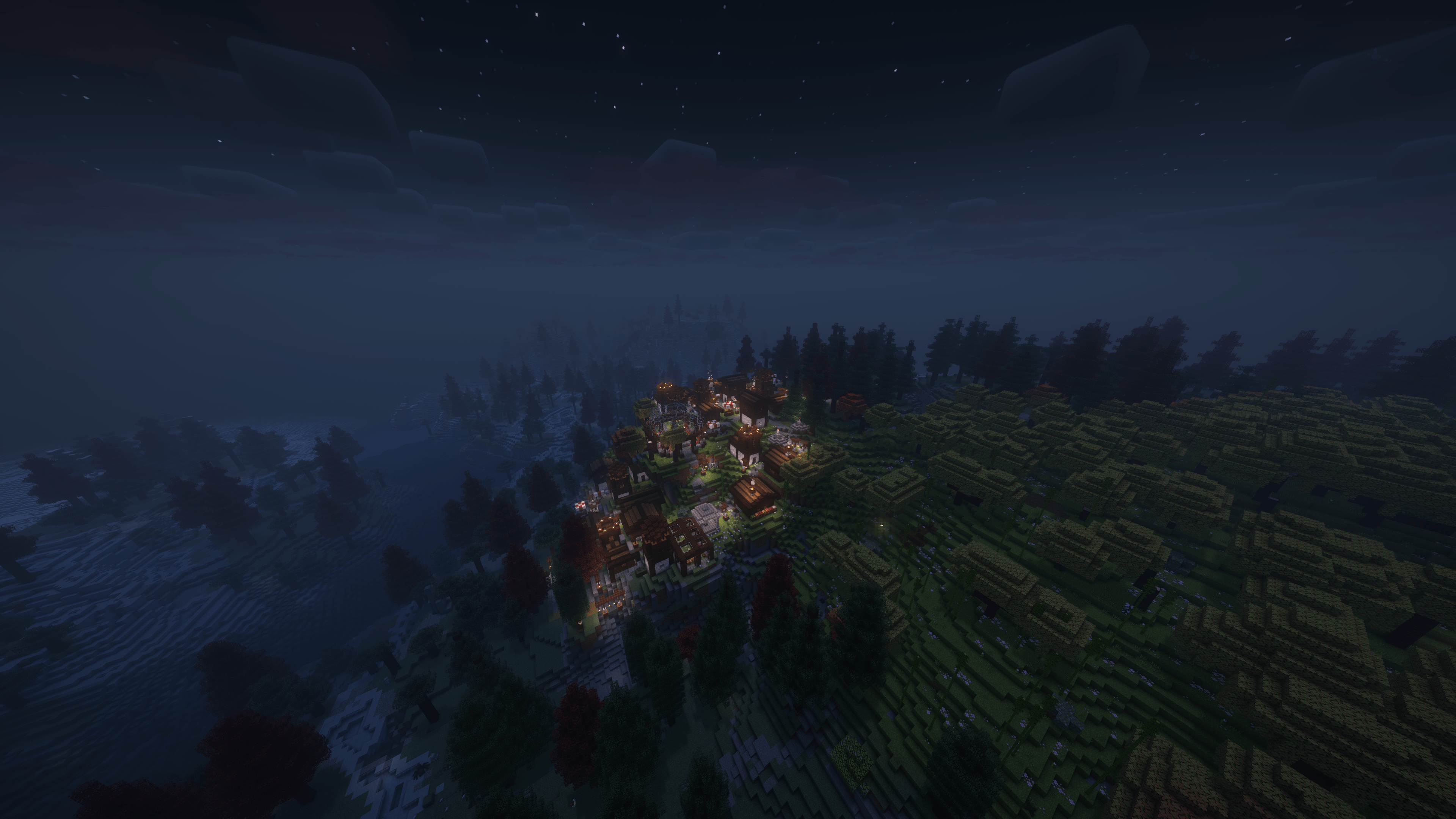 An image of a Minecraft village surrounded by several different modded biomes, at night from above.