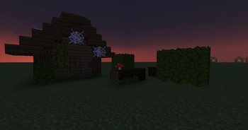 In-game Screenshot of a House and Hedges