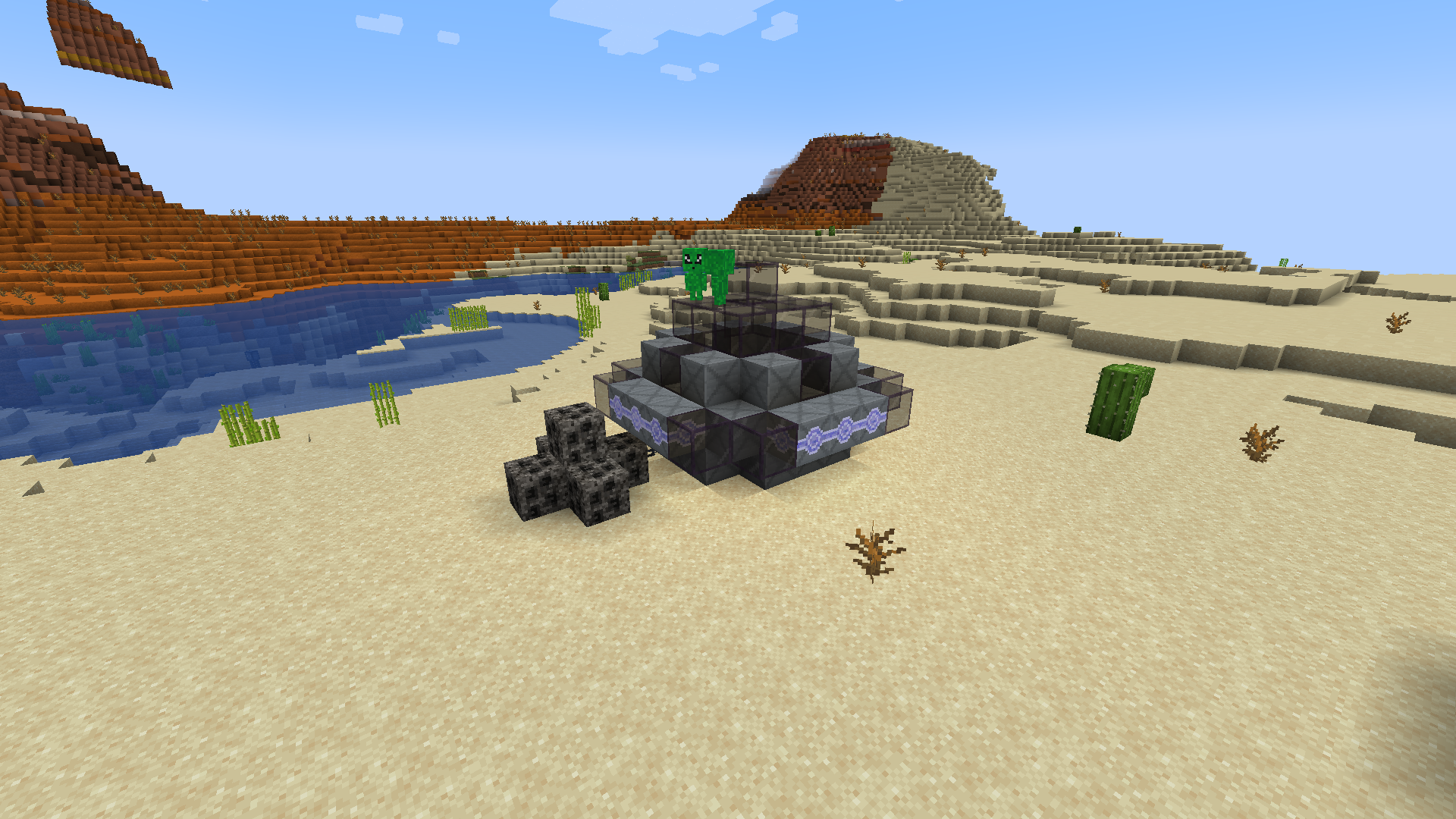 A UFO in the desert with two Little Visitors on top of it and an Ancient Meteor chained next to it
