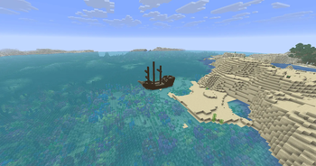 In the warm ocean, a whole ship stands on the shore