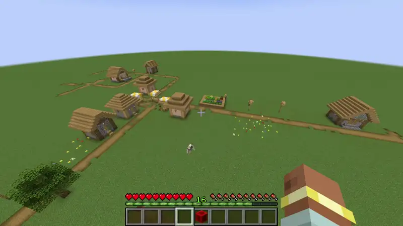 Dropping the last item collapses the network, the comparator's signal falls, and the TNT under a village detonates.