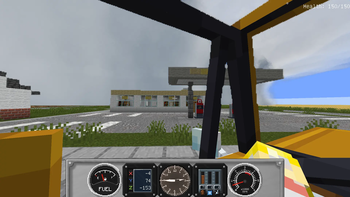 Inside of a car near a storm and gas station