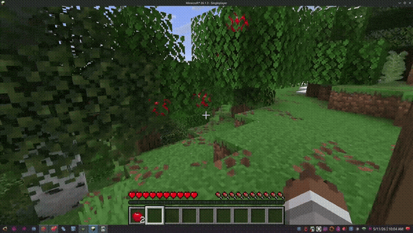 A player in Minecraft collects apples off leaves to demonstrate how the mod works