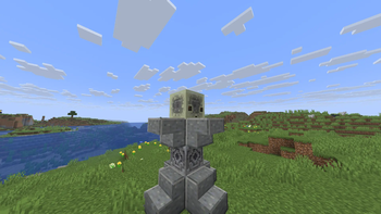 A sulfer cube with chiseled stone bricks sitting on a pedestal