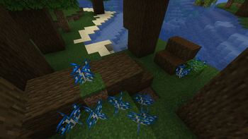 fallen dark oak tree with blue oysters growing out of it 