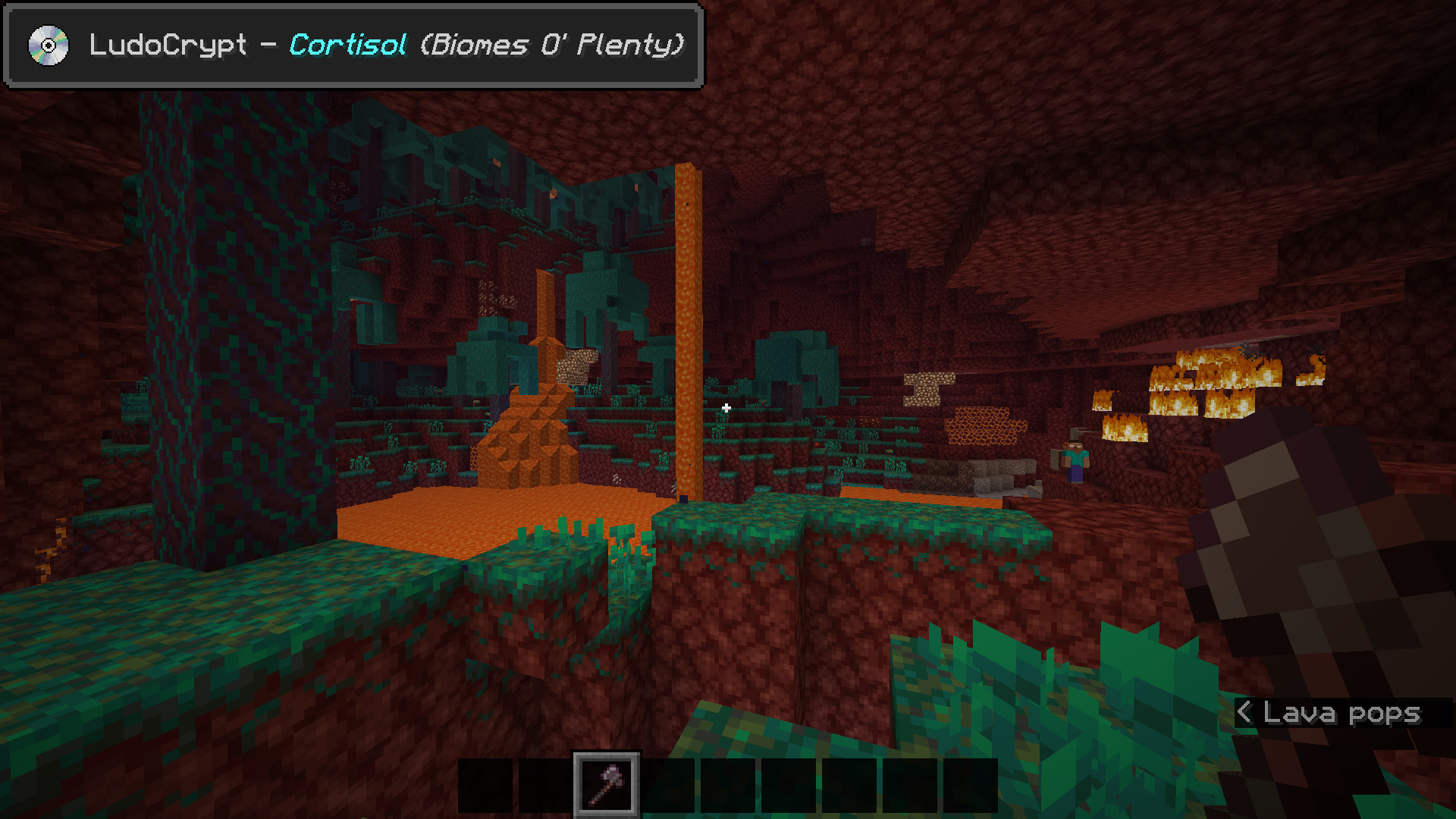 A player in the Nether dimension (vanilla), with a music toast on the top left. It reads "LudoCrypt - Cortisol (Biomes O' Plenty)", which is a music track exclusive to the Biomes O' Plenty mod.