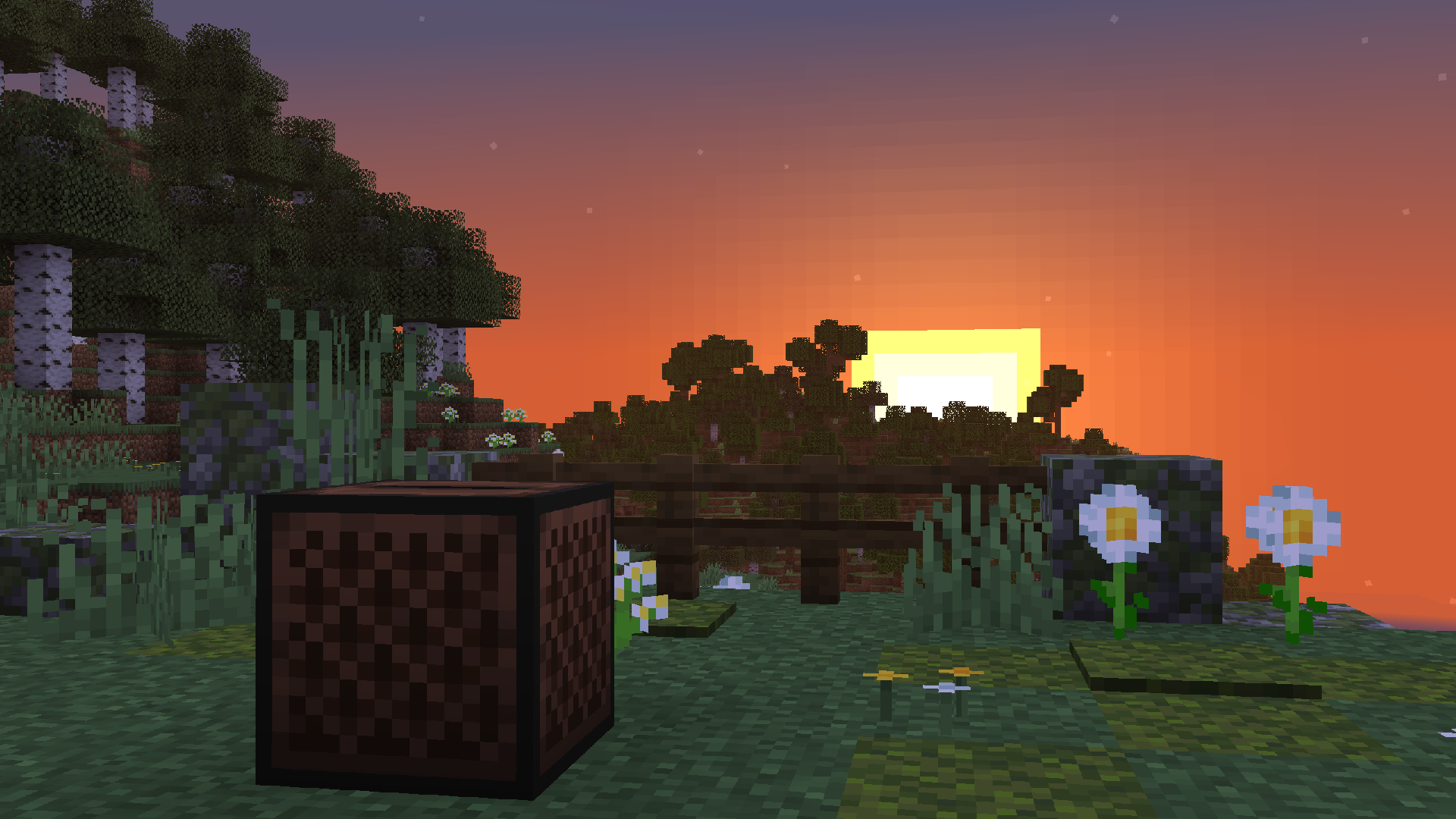 A screenshot of a Jukebox in a meadow during a sunset