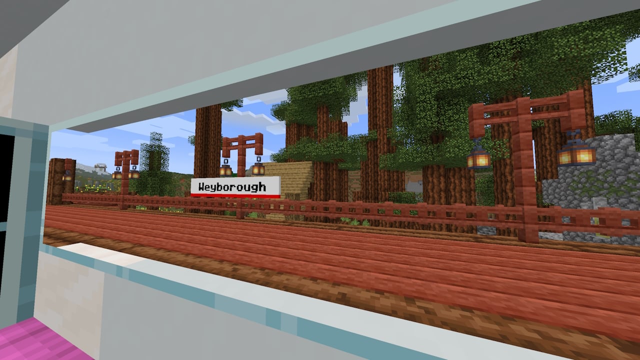 view of a station sign from a train