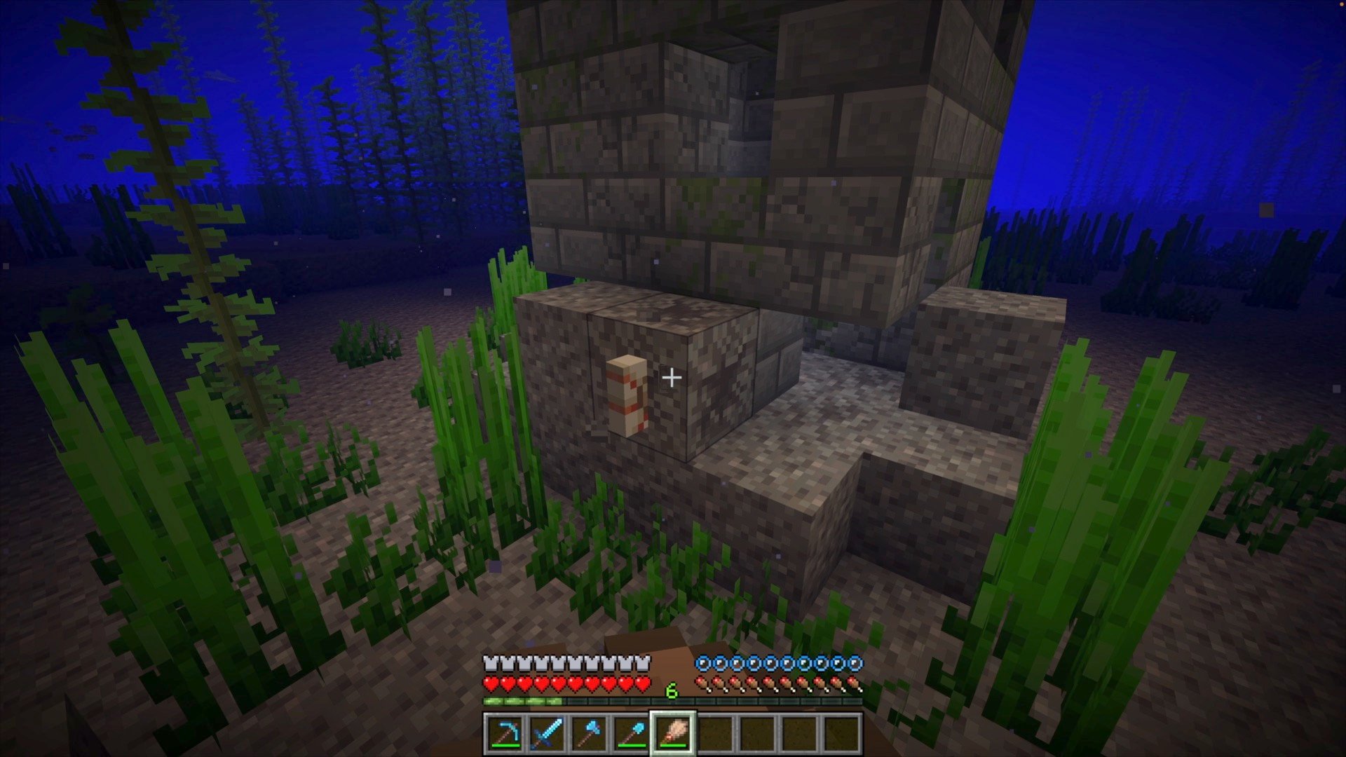 A player brushing a nautilus out of a suspicious gravel block.