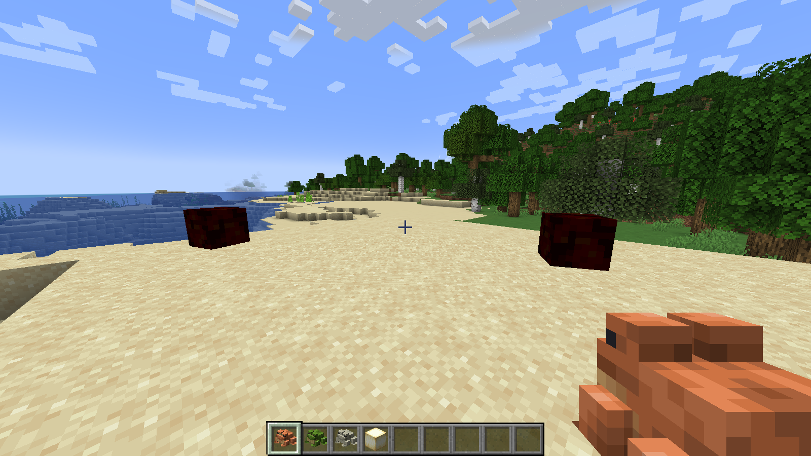 A Handheld Frog and some Magma Cubes, with a froglight in the hotbar.