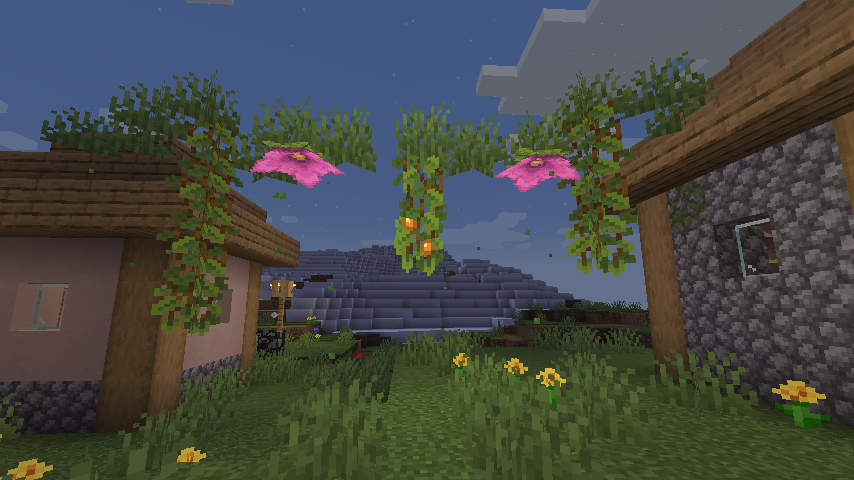 Garland of gras, spore blossom and glow lichen between two houses.