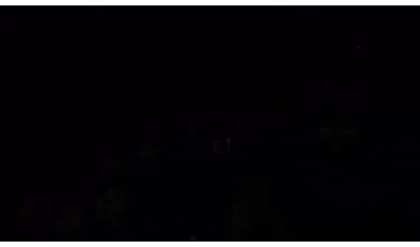 a very dark screenshot of what appears to be a forest with a portal in the middle... There appears to be some kind of creature near the portal