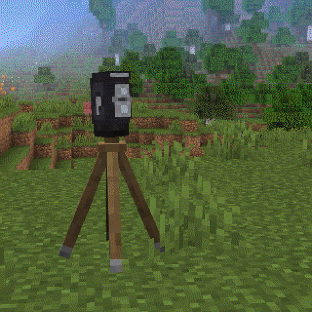 A tlr on a tripod with a field in the background