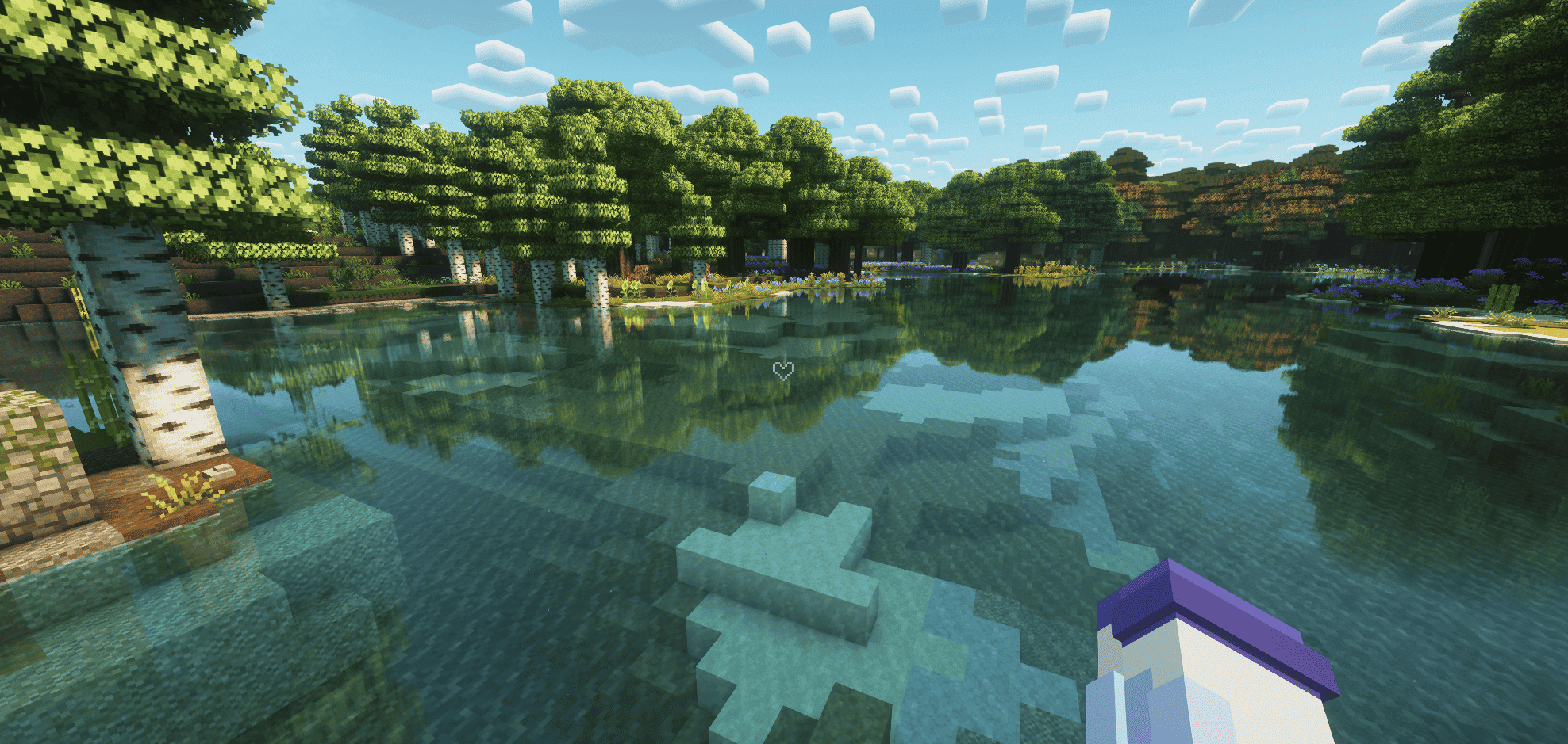 In-game screenshot of Minecraft using shaders, showing a clean user interface in Creative mode. The center of the screen features a custom crosshair shaped like a small heart, glowing slightly against a soft-toned landscape background.