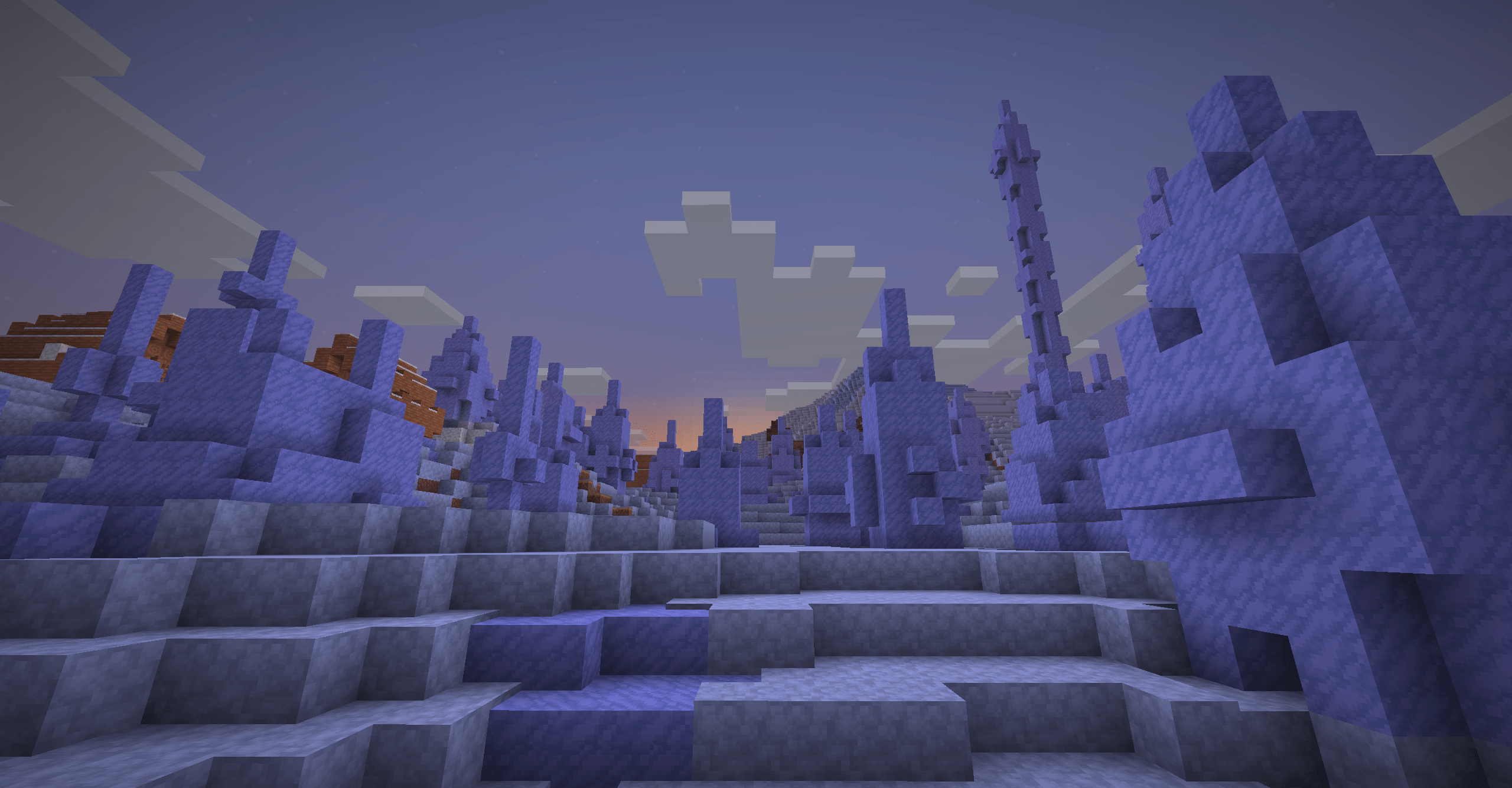 An Icespikes biome with a Snowy Village poking into frame, the landscape is illuminated by a young sunrise