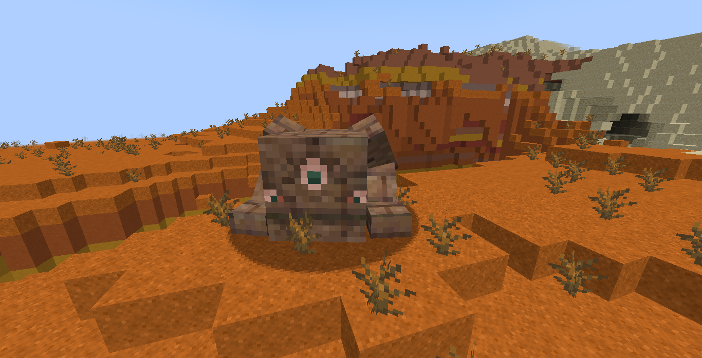 A three block tall giant adobe bricks monster with arms and three eyes with blue pupils