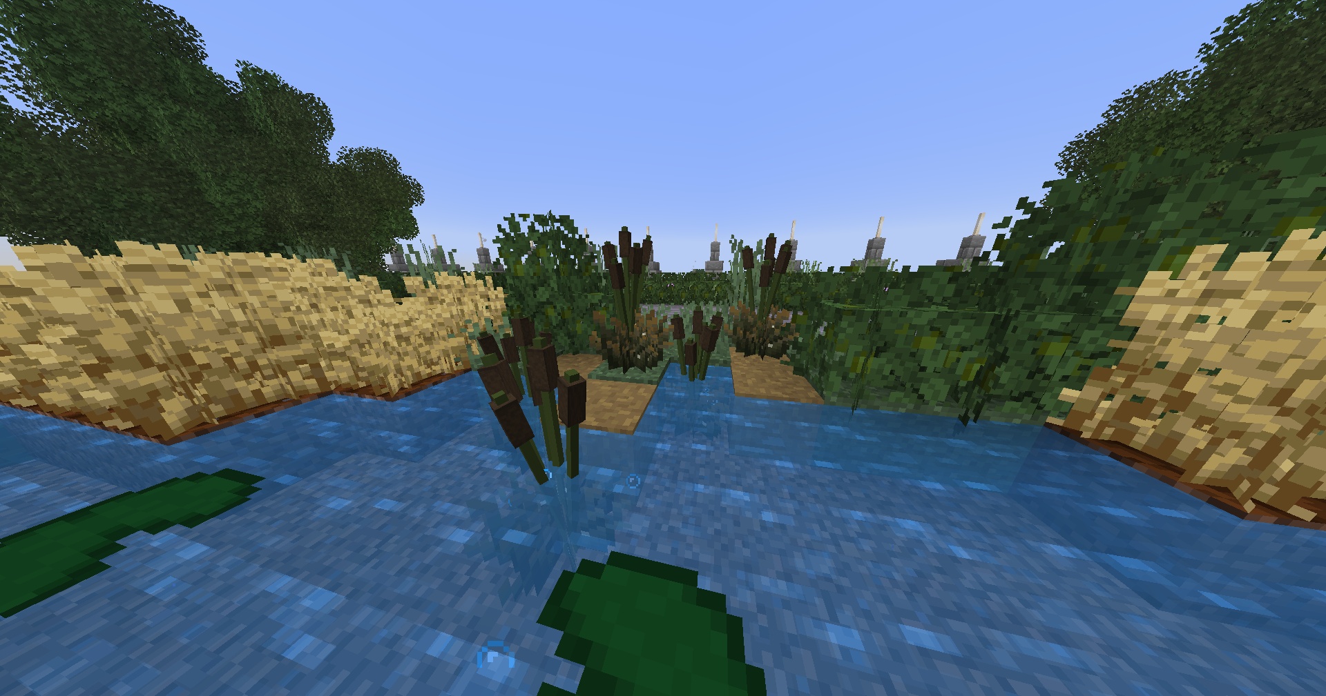 This Minecraft screenshot showcases the Cattails/Reeds furniture models integrated into a natural pond environment. The image highlights how these custom plants enhance waterfront landscaping.