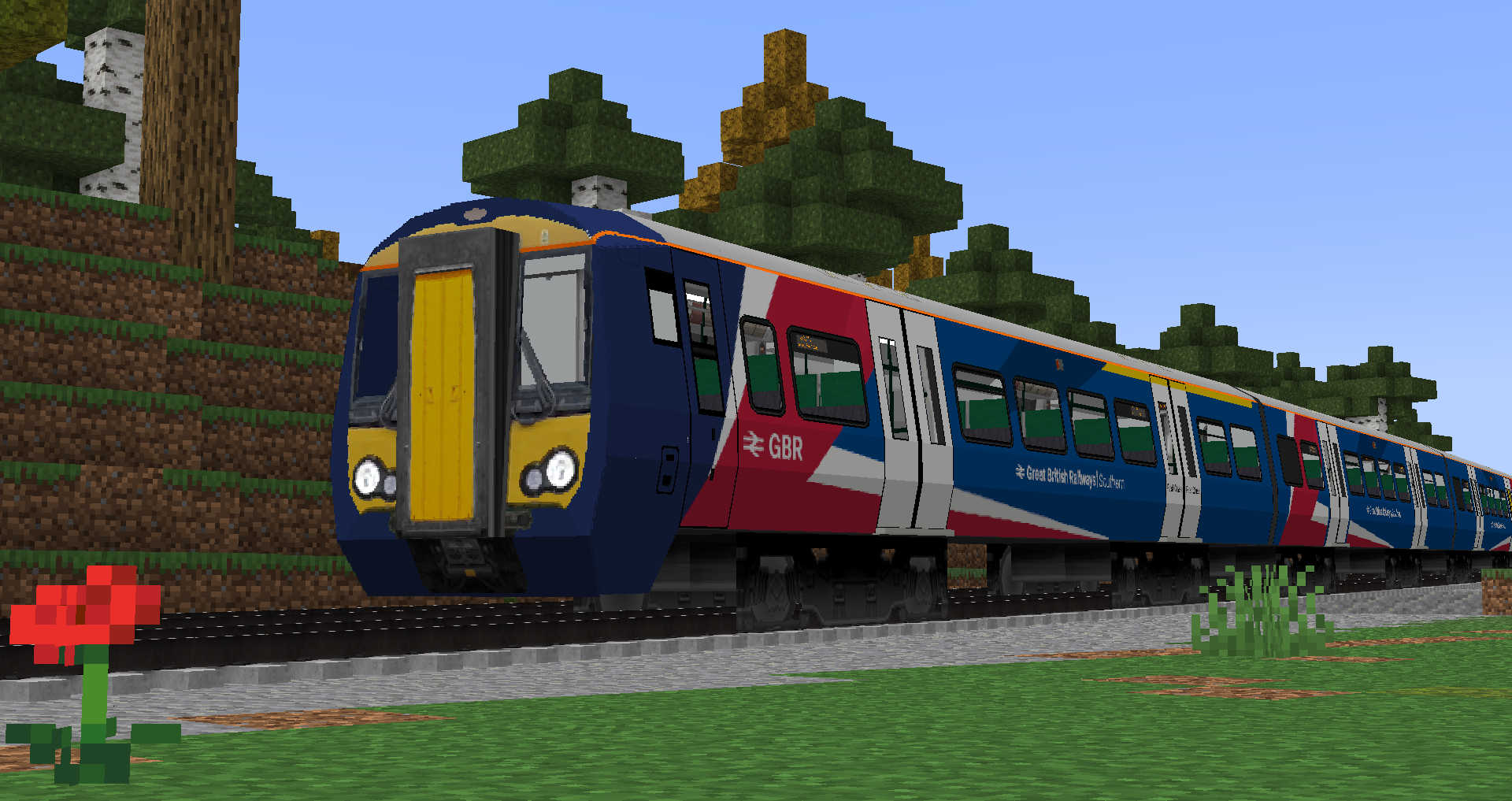Class 387 in Great British Railways passing a camera in the countryside
