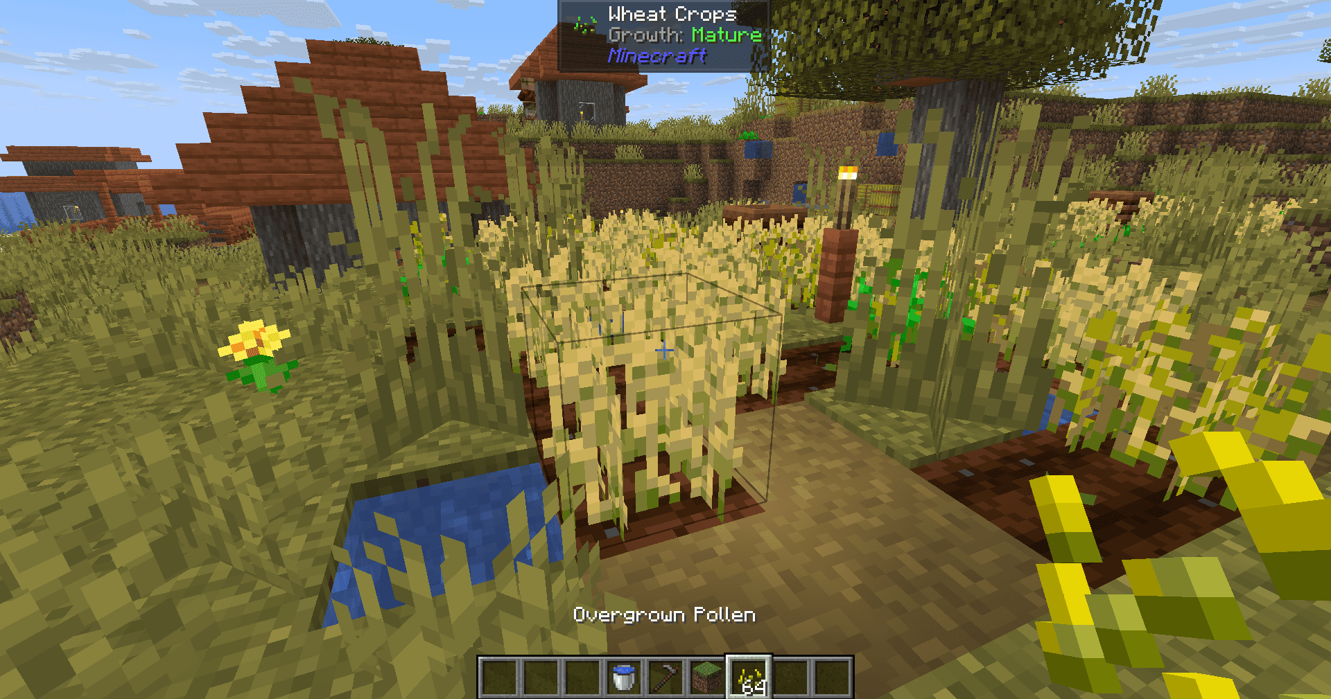 Player holding Overgrown Pollen, looking at crops in a savanna village