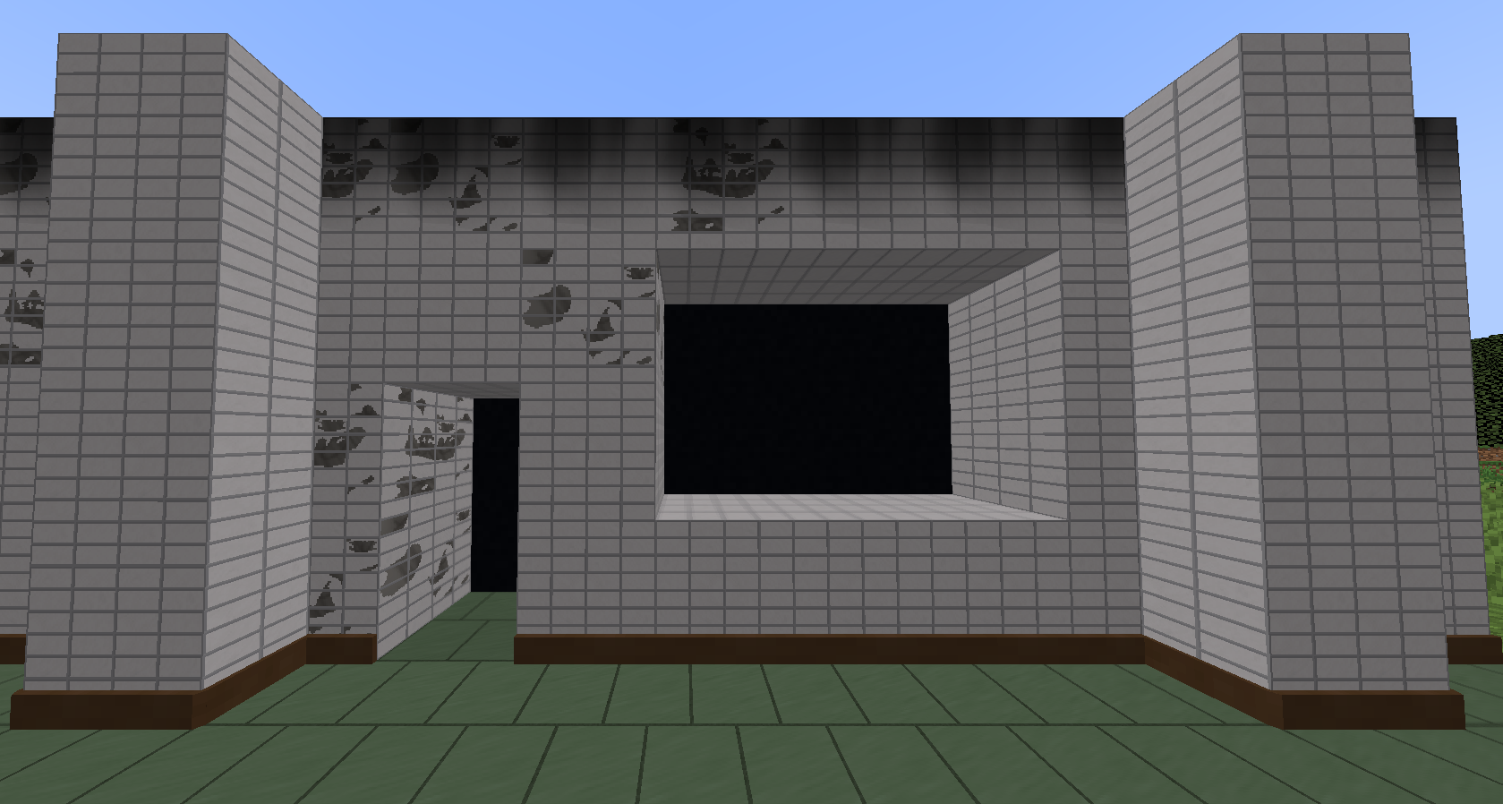 Wall made of white tiled blocks. There is 2 holes. One for a door, and one for a window.