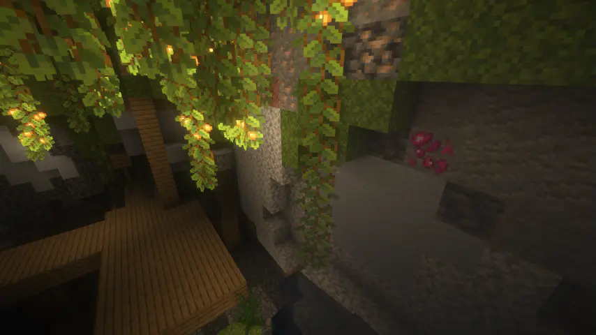 Heart Crystal Ore embedded in the wall of a Lush Cave and above a mineshaft, with shaders.
