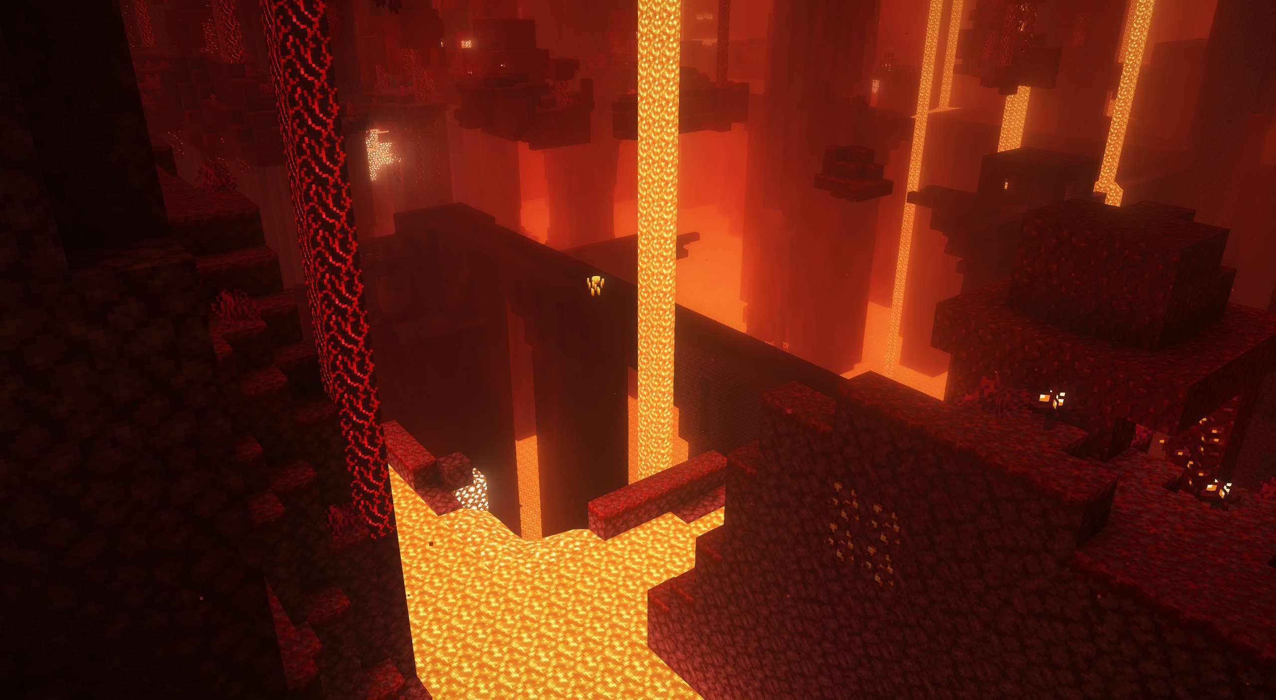 A view down to a nether fortress. In the forground is a lava river at higher elevations.