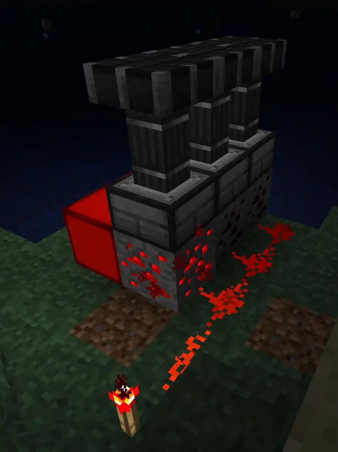 A line of redstone running along redstone ore, powering pistons and lamps