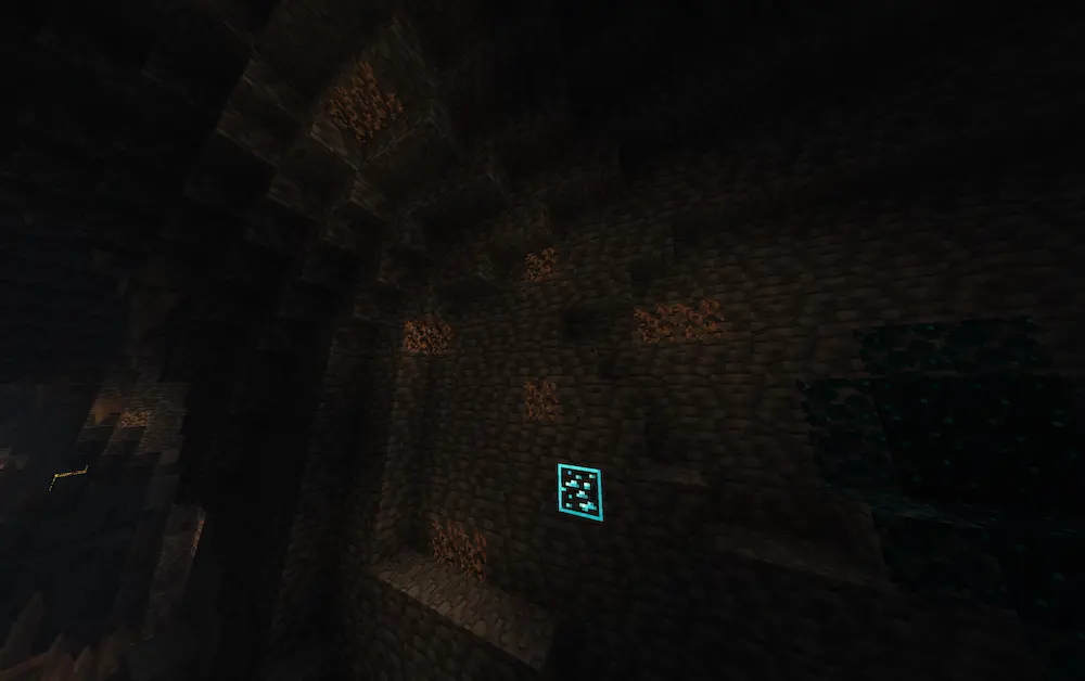 Glow lichen on a wall in a dark cave with diamonds