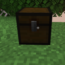 a darkened trap chest in a grassy environment