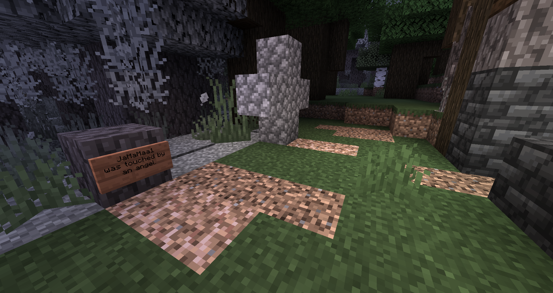 image of a creaking angels gravestone next to a graveyard