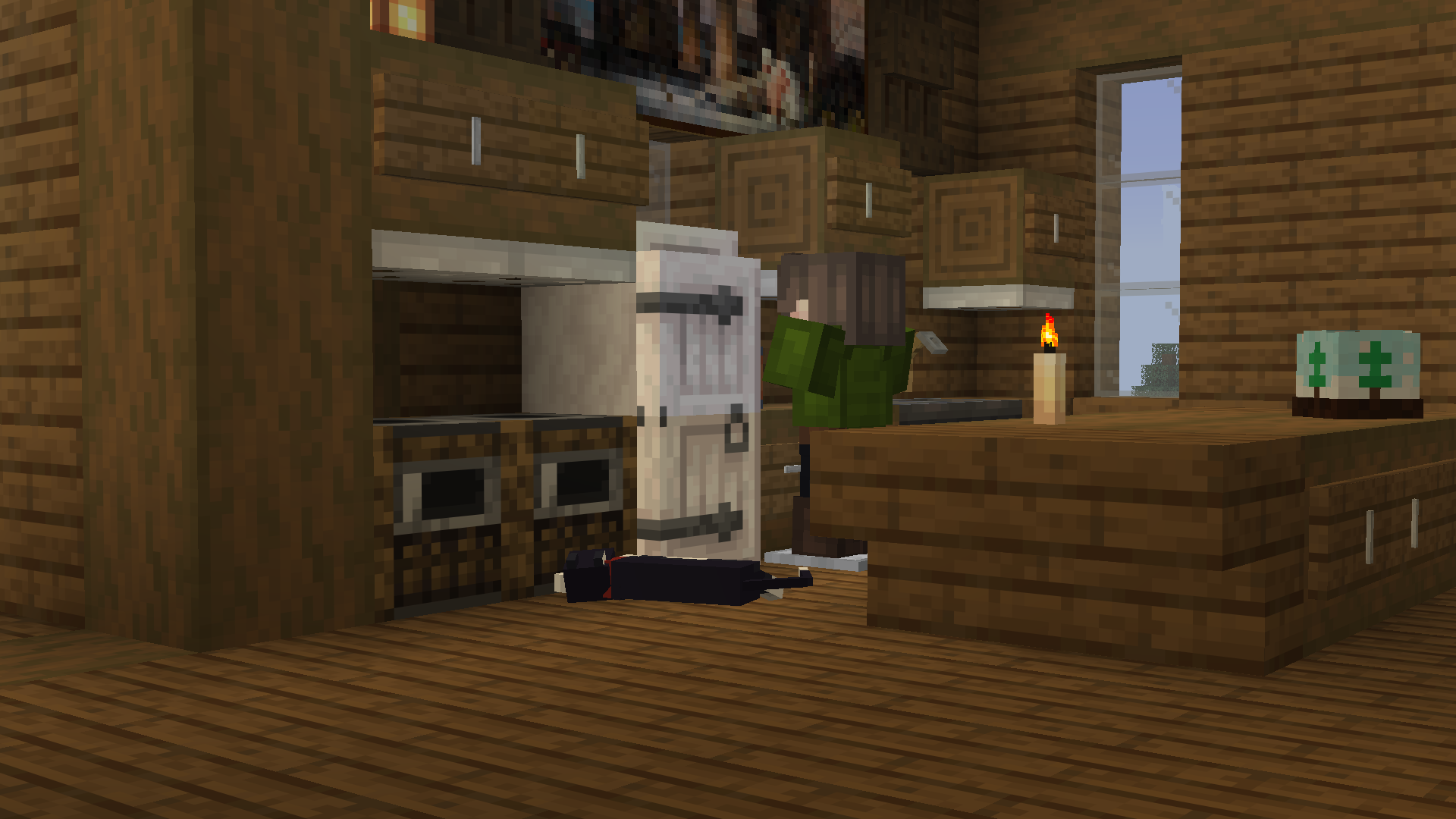 A cat laying on a wooden kitchen floor.
