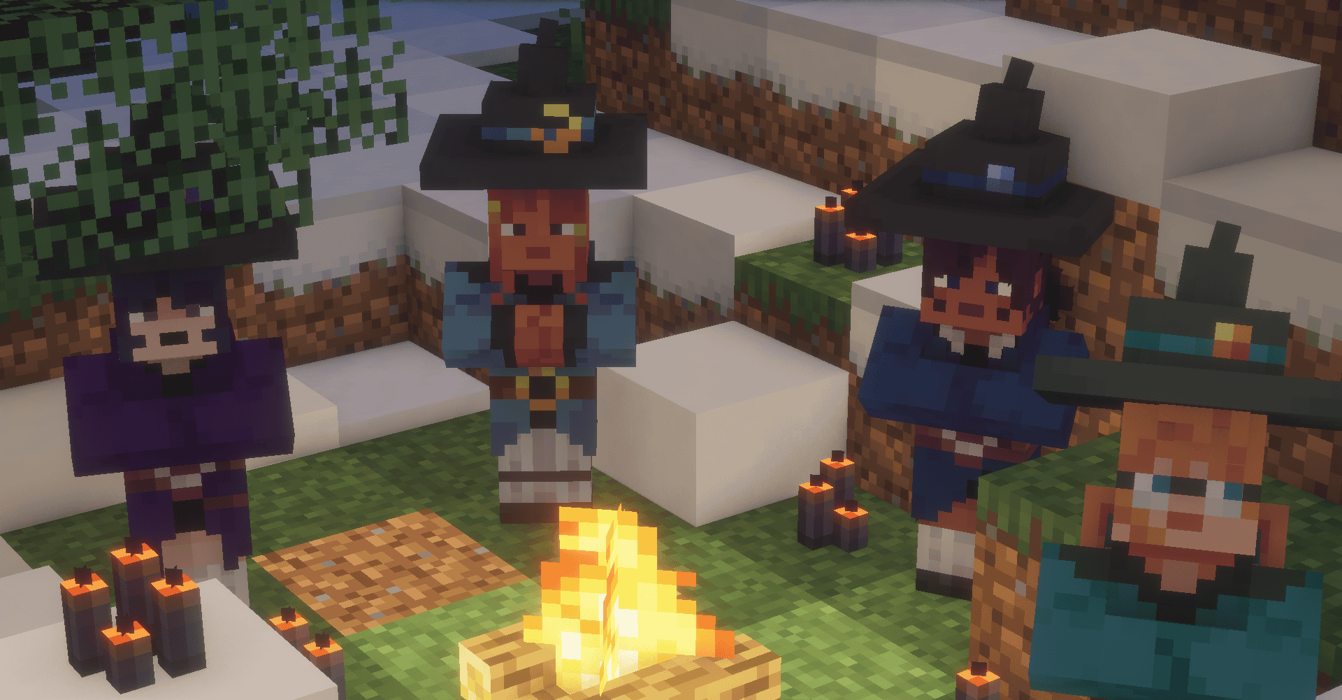 A coven in the snow with fire in the middle