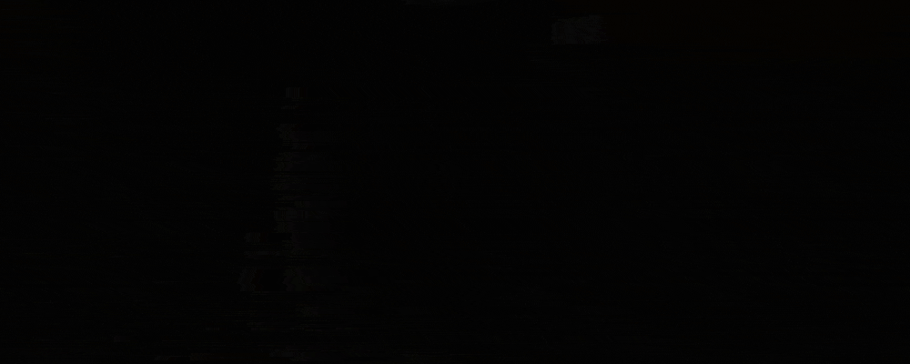 A pitch black cave momentarily lit up by a flare shot down it