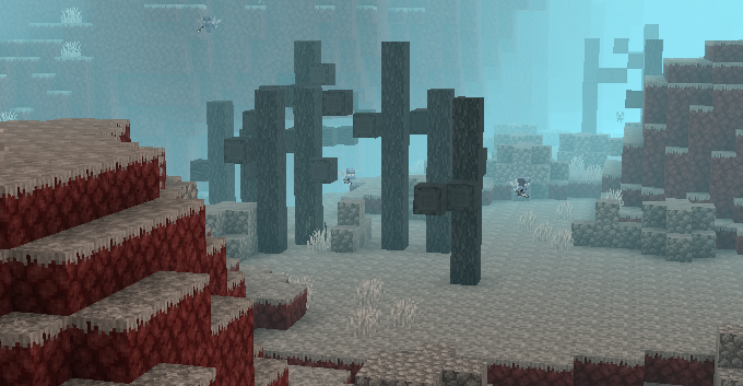 A gray biome with dead trees and boulders. The fog is blue. Vexes are flying around.