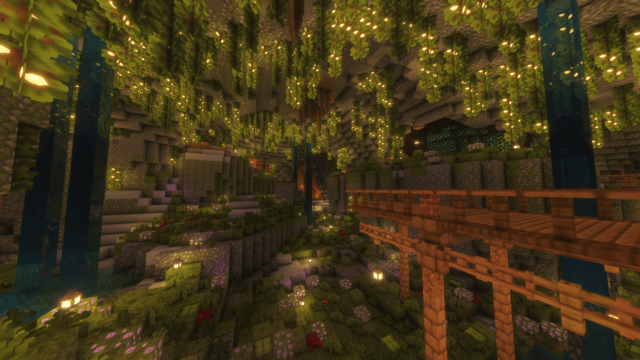 An image of a brightly lit Lush Cave mine, with veins of Tungsten visible to the right of the image, and vines covered in berries attached to the roof of the cave.