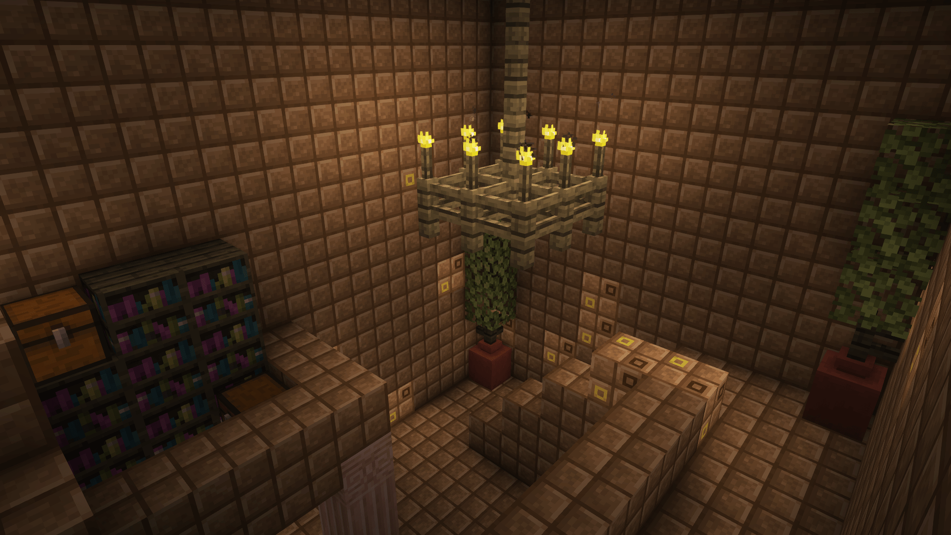 an interior of library with bookcase, potted plants and chandelier