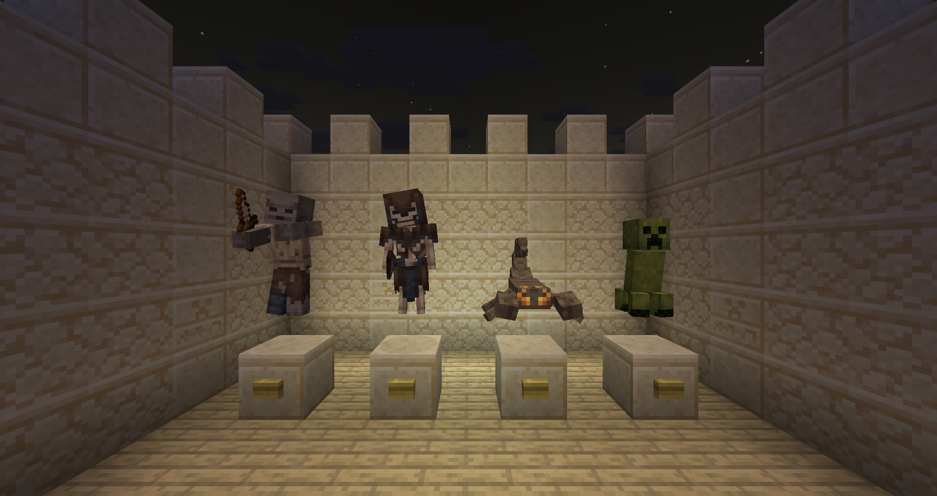A zombie, skeleton, spider and creeper displayed above cut sandstone blocks