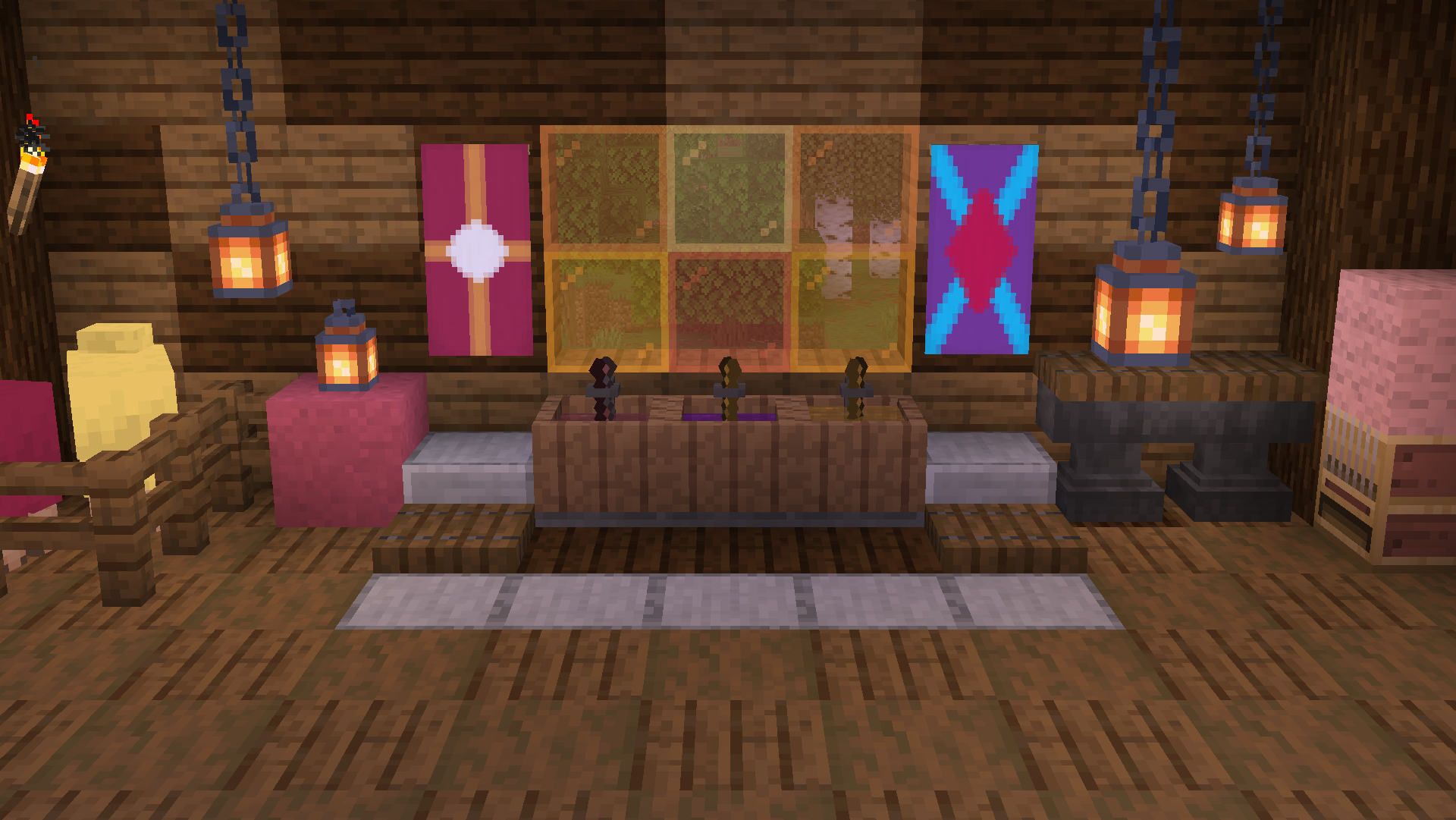 3 Dye vats sit in a room with spruce and dark oak walls and flooring. The vats are made of wood. The vats have shovels in them, and the water in them is colored - from left to right - burgundy, purple, and orange. Above the vats are stained glass blocks with various shades of orange. 2 banners can be seen on the wall, one is rose colored with an orange cross and white dot. One is purple with a cyan diagonal cross with a fuchsia diamond in the middle. There are 2 sheep in a pen to the left, colored light yellow and rose. Lanterns hang from the ceiling.