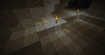 A patch of gold ore and a patch of iron ore deep in an underground cave