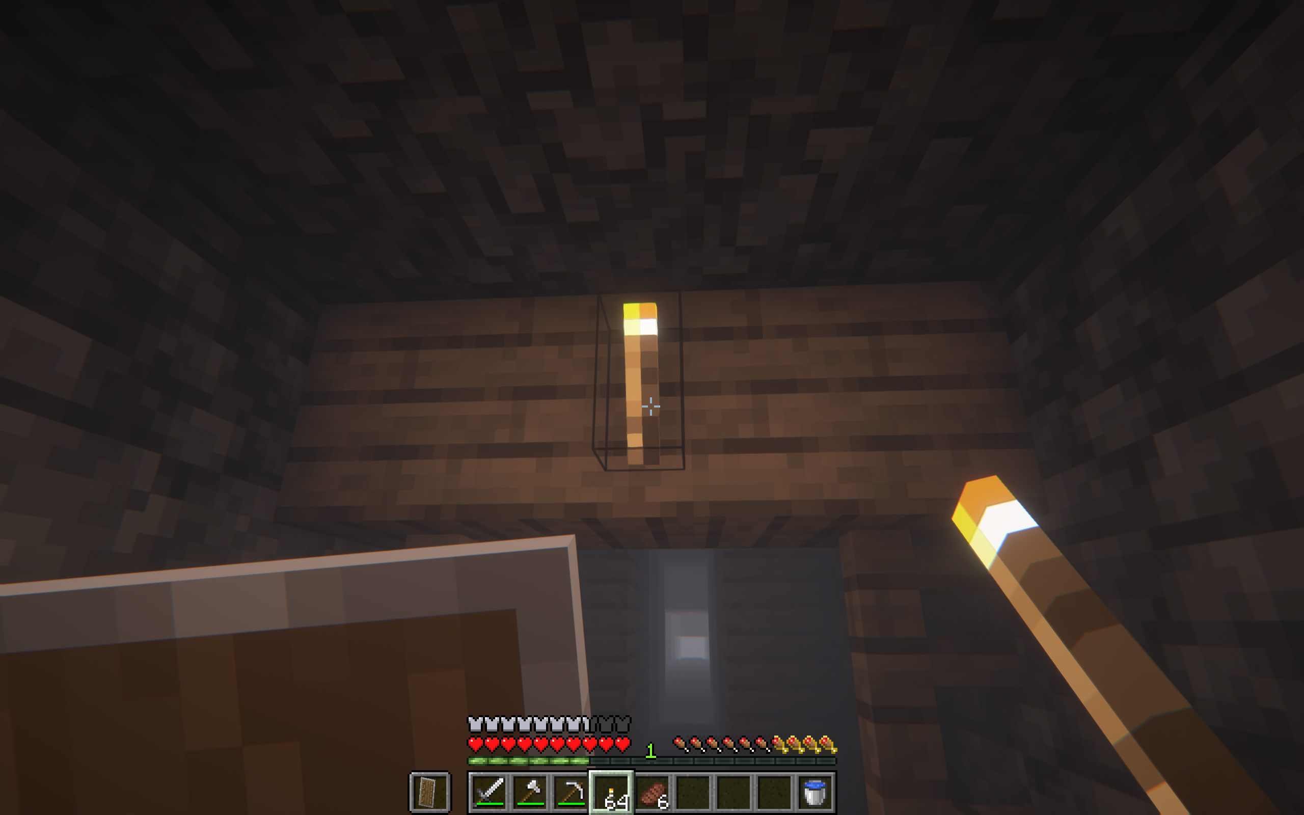 A player igniting a torch in an abandoned mineshaft