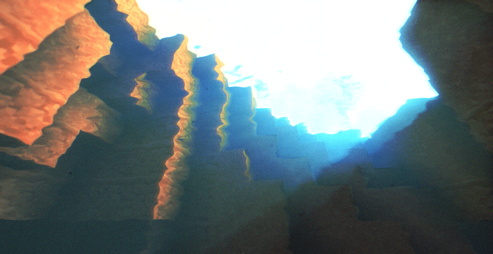 Underwater cave with lightshafts coming trough
