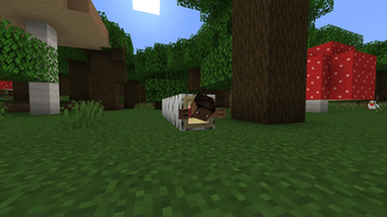 A player crawling inside a hollow log