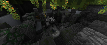 A spider dungeon inside a lush cave